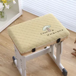 Close-up detail of thickened student chair cushion with cute mushroom embroidery.