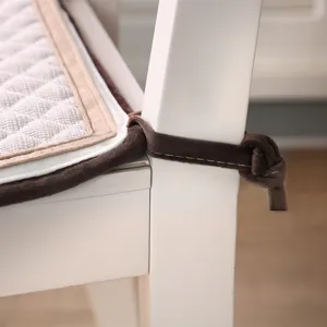 Close-up detail of quilted chair cushion with soft plush ties for secure seating comfort.