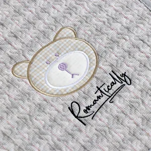 Detailed view of thickened quilted chair cushion featuring cute embroidered bear and stylish text.