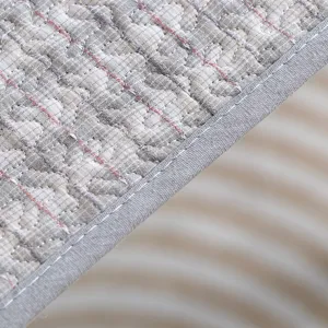 Close-up detail view of thickened chair cushion fabric, quilted embroidery texture and gray edge binding.