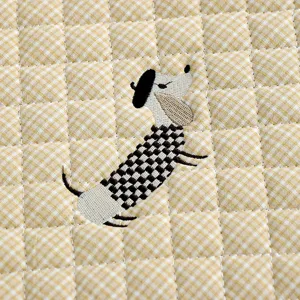 Close-up detail of thickened quilted chair cushion featuring cute embroidered puppy pattern.