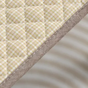 Quilted chair pad detail shot showing yellow gingham fabric and brown trim edging.