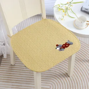 Close-up of the embroidered puppy pattern and soft textured surface of the chair cushion.