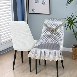 Detailed view of home dining chair cushion set featuring elegant grey quilted fabric and lace trim.