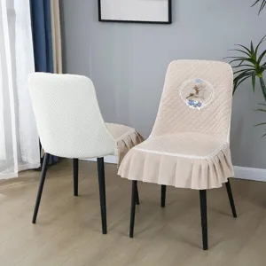 Quilted chair cover with elegant embroidery and ruffle skirt, non-slip dining seat protector.