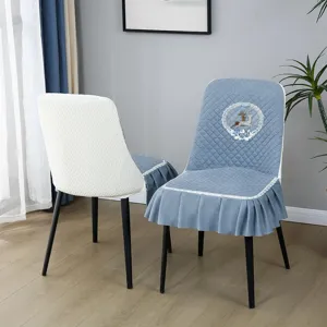 Detailed view of quilted chair cover with elegant ruffle skirt and cute deer embroidery design.