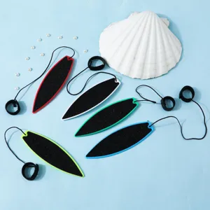 Detailed view of five colorful mini finger surfboards with black leashes on blue