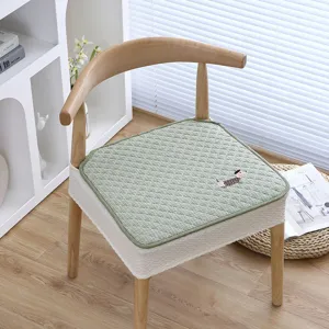 Detailansicht des elastischen Esszimmerstuhlbezugs und des grünen karierten gesteppten Sitzkissens.