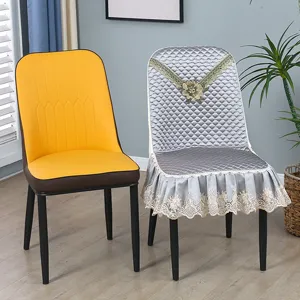 Detail view of a luxury quilted dining chair cover in silver grey with elegant lace trim.