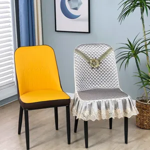 Detailed shot of elegant dining chair with quilted lace cover, luxury home interior setting.