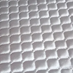 Detailed close-up of silver gray quilted chair cover fabric, showing neat stitching texture.