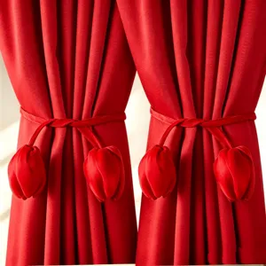 Close-up detail shot of red velvet tulip curtain tieback, elegant home decor accessory ornament.