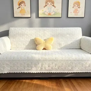 Gedetailleerd uitzicht van de gewatteerde beige bankhoes met waaiermotief en schattig kussen.