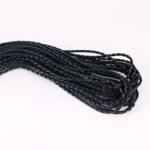 Detailed macro view showing the texture of bundled black braided necklace cord strings