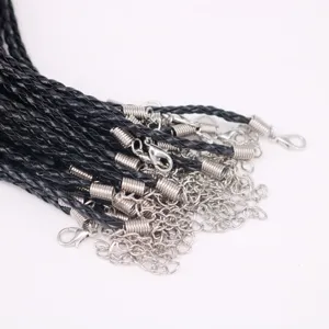 Detailed view of black braided necklace cords featuring silver metal lobster clasps