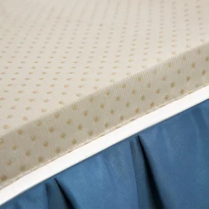 Gros plan de la texture douce et antidérapante beige associée à une jupe plissée bleue.