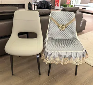 Detailed shot of luxury full-wrap chair cover with delicate gold lace embroidery for dining room.