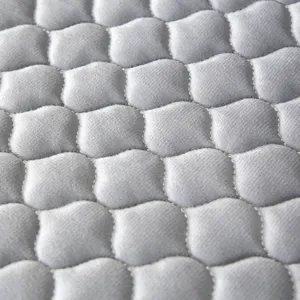 Thickened quilted cushion cover fabric detail, soft gray padded waiting chair pad texture.