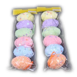 Detail view of two packs of glittery foam Easter eggs with hanging ribbons.