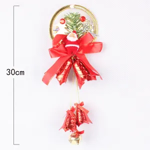 Detailed view of a 30cm Christmas hanging ornament with bells, Santa Claus and a red bow