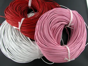 Close-up of red, pink, and white leather cords for DIY jewelry making.