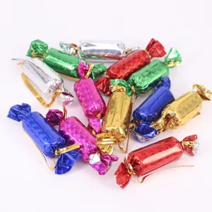 Close-up of colorful foiled Christmas candy-shaped ornaments for festive tree decoration