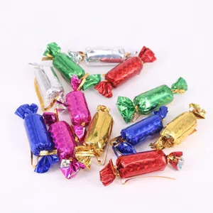 Macro view of assorted colorful holographic candy-shaped Christmas tree ornaments