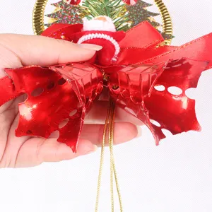 Detail showing red Christmas bells and a miniature Santa Claus for tree decoration