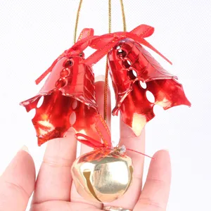 Close-up of red leaf-shaped bells and gold round bell Christmas decoration