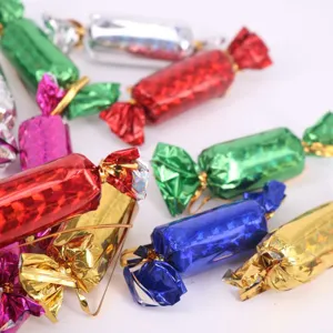 Detail showing glittery texture of colorful candy-shaped Christmas tree hanging ornaments