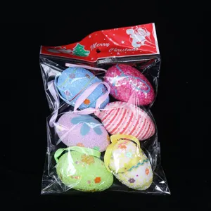 Detailed view of six decorative foam Easter eggs with hanging ribbons in clear packaging