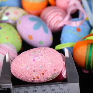 Macro view measuring pink glittery foam Easter egg with a digital caliper.