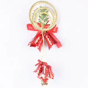 Detail of 30cm Christmas decoration featuring triple gold rings, red bows, and bells