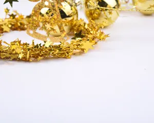 Festive shiny gold Christmas star tinsel garland for holiday tree and home decoration