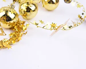 Sparkling golden Christmas star tinsel garland with reflective baubles for decor