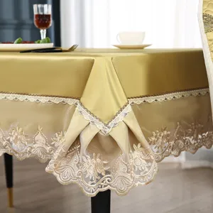 Exquisite goldene Spitzen-Tischdecke mit feiner Stickerei fuer elegante Esszimmertisch-Dekor.