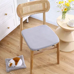 Cozy wooden chair detail with thick grey cushion in bright room setting lifestyle shot.