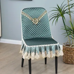 Detailed shot of the luxury dark green quilted dining chair cover with elegant lace trim.