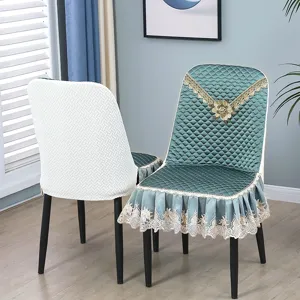 Dining chair cover detail view showing delicate lace ruffles and quilted texture design.