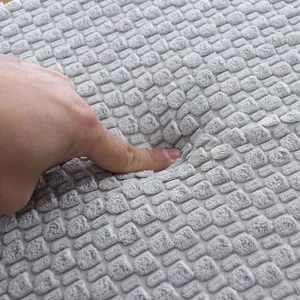 Close-up view showing the soft texture and thick padding of the grey winter cushion fabric.