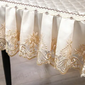 Elegant quilted dining chair cover with delicate gold embroidery lace skirt for luxury home decor.