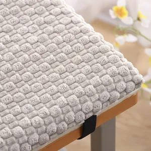 Close-up view of a thick plush seat cushion featuring soft textured 3D fabric for cozy seating.
