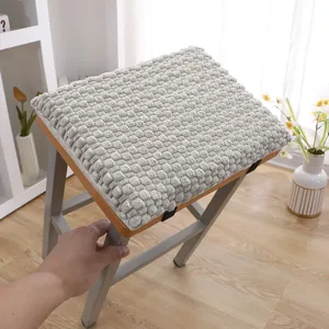 Detailed view of grey textured plush seat cushion on stool, soft winter chair pad fabric closeup
