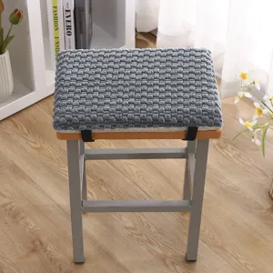 Grey plush chair cushion with memory foam and ties for home and office comfort.