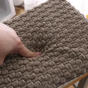 Close-up detail of thick plush seat cushion, soft textured surface for winter warmth.