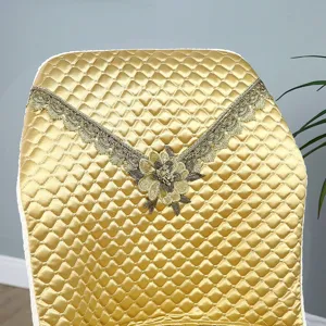 Gold quilted dining chair cover with lace trim and floral embroidery, backrest slipcover.