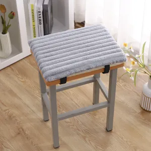 Grey thick plush stool cushion detail, soft ribbed texture with secure straps for indoor chairs.