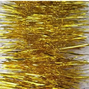 Detailed close-up of golden metallic Christmas tinsel garland with dense shiny strips