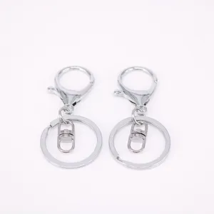 Detailed view of silver metal lobster clasps and flat key ring accessories for DIY crafts