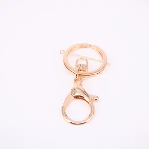 Detail view of shiny gold lobster clasp and flat keyring DIY jewelry accessories